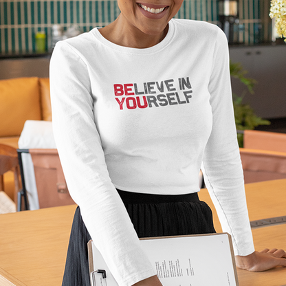 A woman wears the BElieve in YOUrself Premium Sober Apparel long-sleeve, sharing a message of hope and personal growth.
