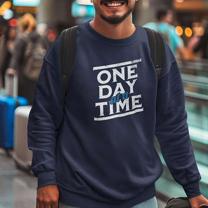 One Day At A Time Premium Sober Apparel worn by a woman in a black sweatshirt, featuring an inspiring recovery message that celebrates steady growth and resilience.
