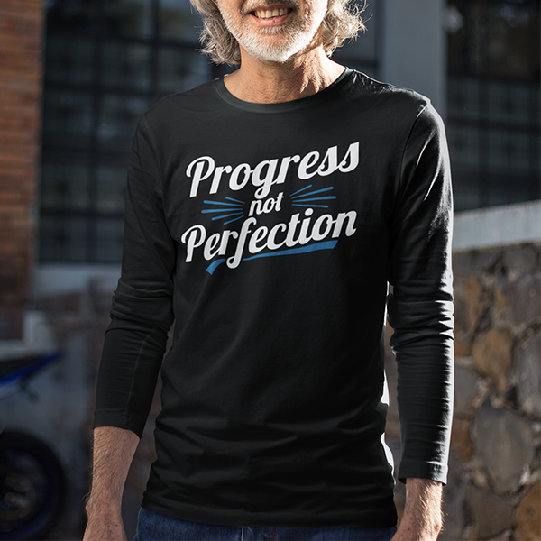 Man wearing Progress Not Perfection Premium Sober Apparel in a casual outdoor setting.